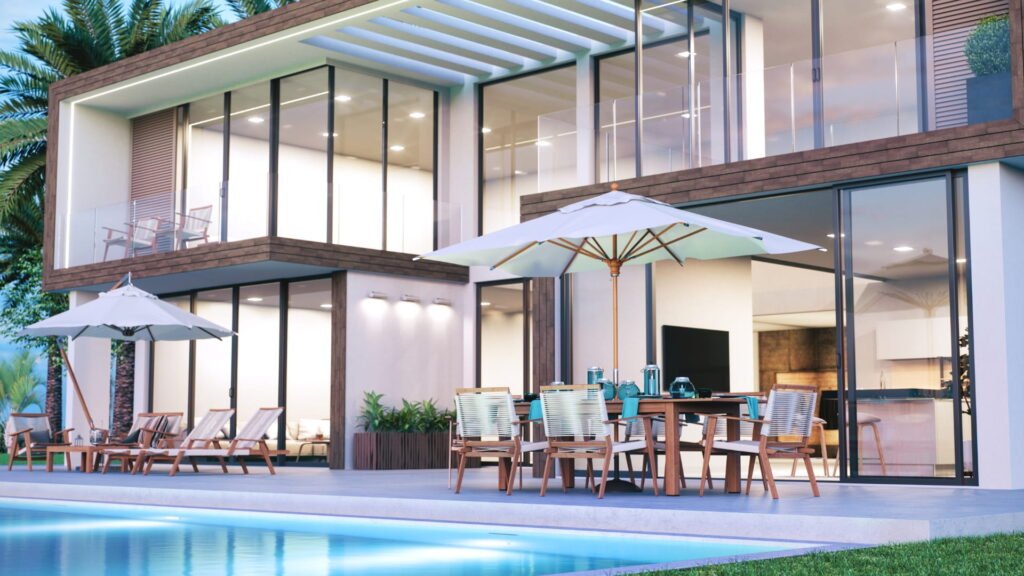 California real estate house with glass windows, pool, patio dining, umbrellas, and palm trees.