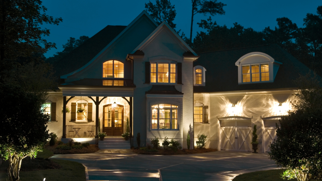 California real estate house with large windows, front porch, driveway, and two garages.
