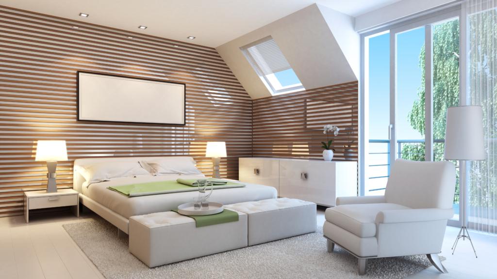 Bedroom with striped wood wall, large bed, lamps, armchair, and windows.